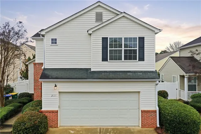 a front view of a house with garage