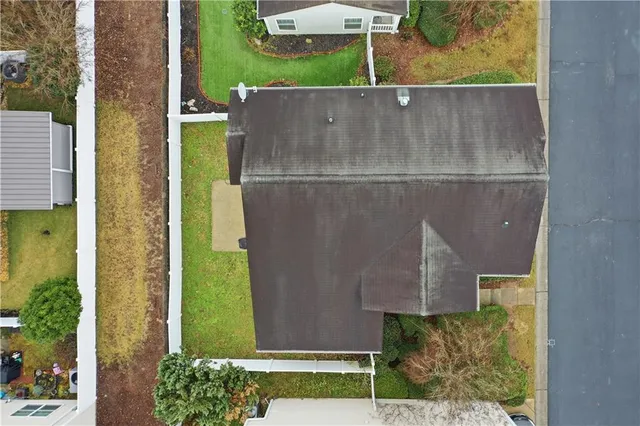 an aerial view of a house with a yard