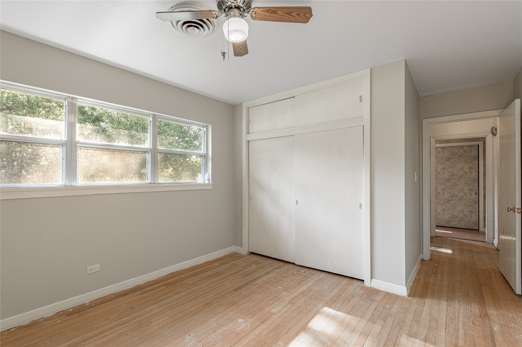 2001 Ave Q Huntsville, TX 77340 - Photo 17 of 18 wooden floor in an empty room with a window