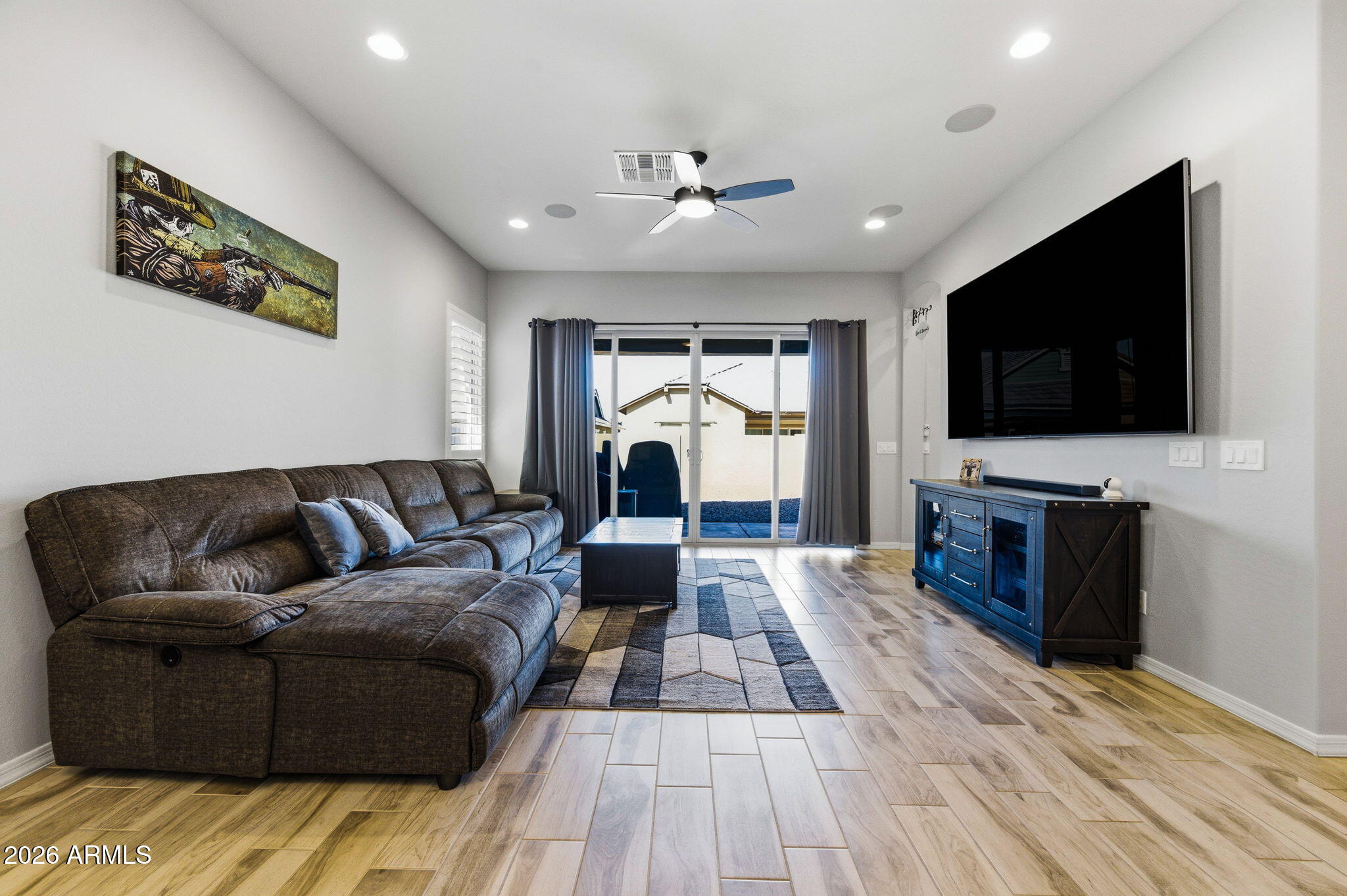 23066 East Mayberry Road Queen Creek, AZ 85142 - Photo 10 of 39 a living room with furniture and a flat screen tv