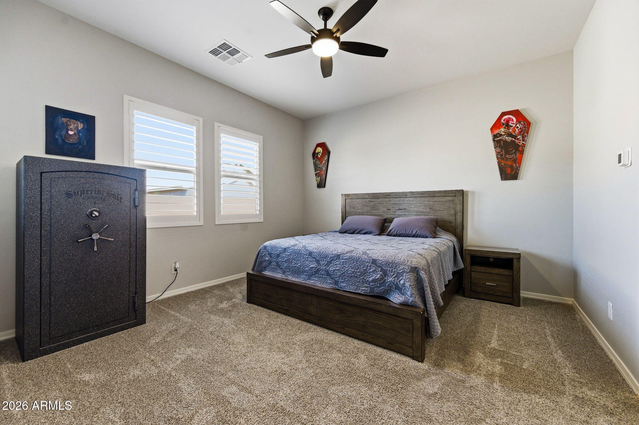 23066 East Mayberry Road Queen Creek, AZ 85142 - Photo 12 of 39 a bedroom with a bed and a chandelier