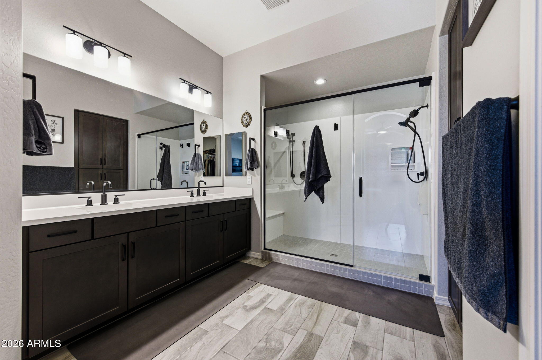 23066 East Mayberry Road Queen Creek, AZ 85142 - Photo 14 of 39 a bathroom with a double vanity sink mirror and shower