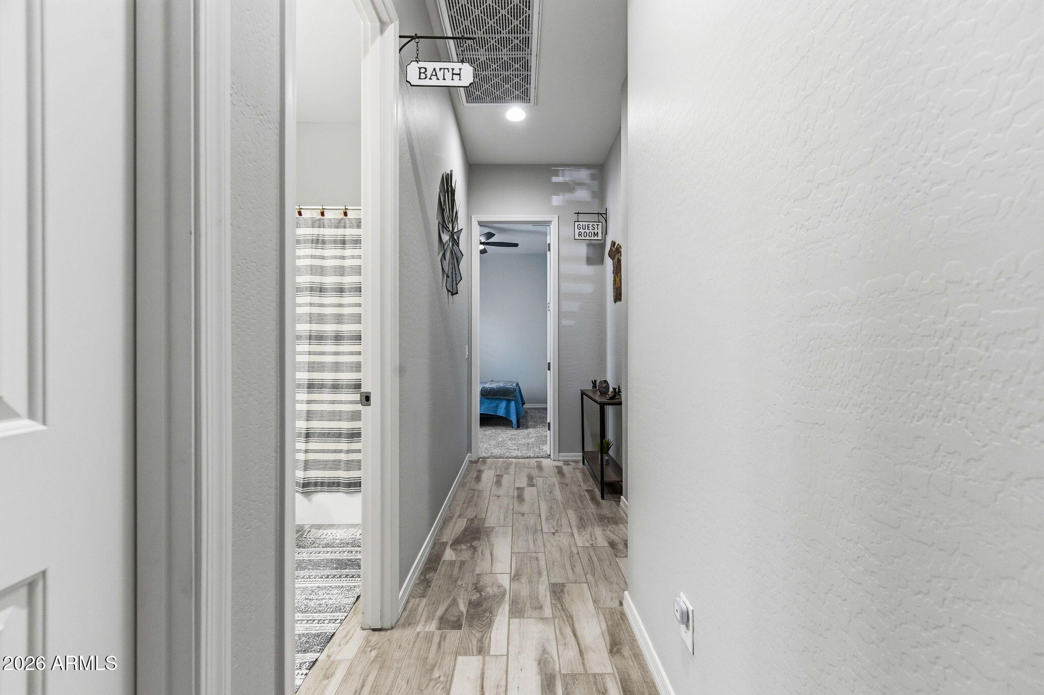 23066 East Mayberry Road Queen Creek, AZ 85142 - Photo 21 of 39 a view of a hallway with wooden floor and staircase