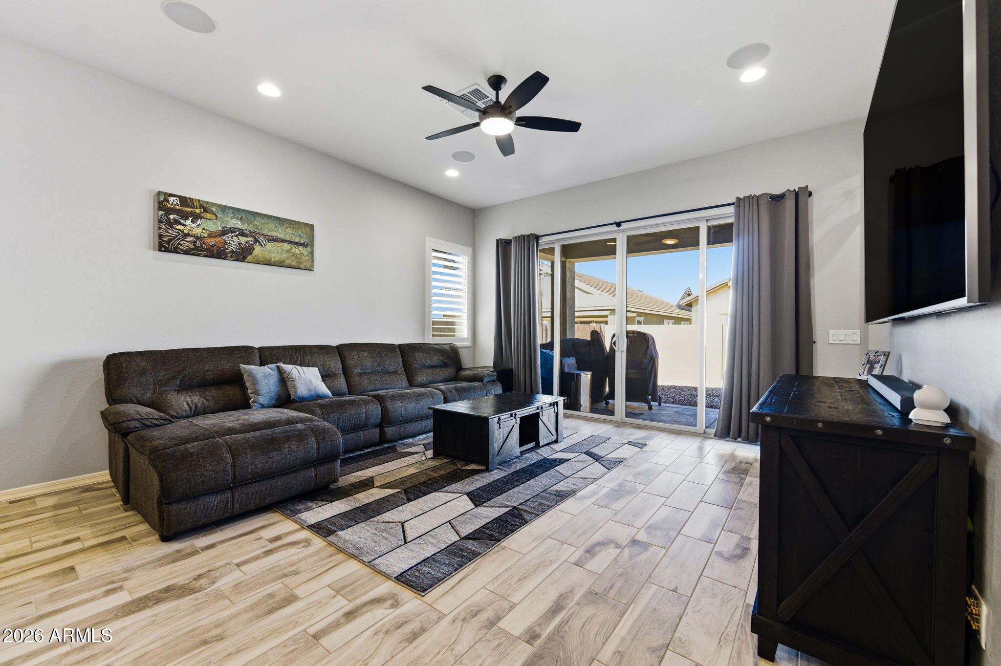 23066 East Mayberry Road Queen Creek, AZ 85142 - Photo 9 of 39 a living room with furniture and a flat screen tv