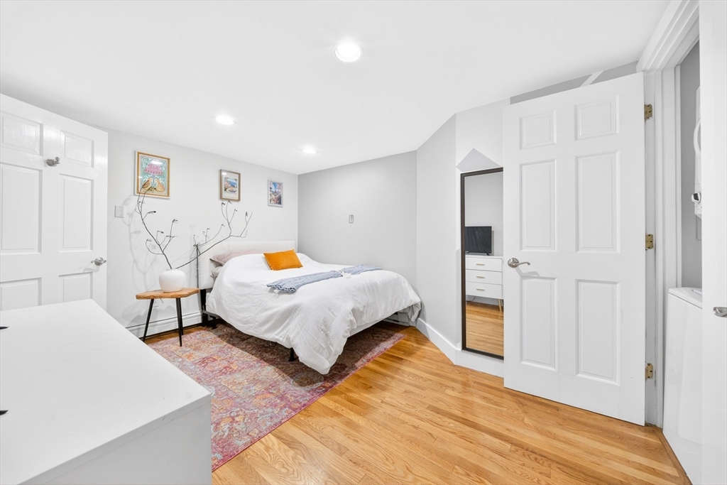 352 Tappan Street, Unit 1 Brookline, MA 02445 - Photo 27 of 42 a bedroom with a bed and wooden floor