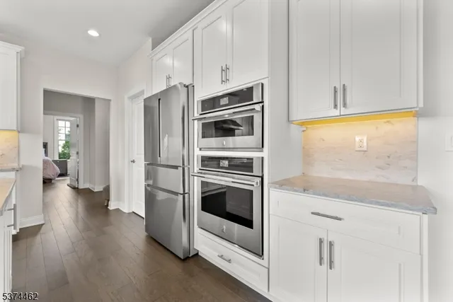 a kitchen with stainless steel appliances granite countertop a stove and a refrigerator