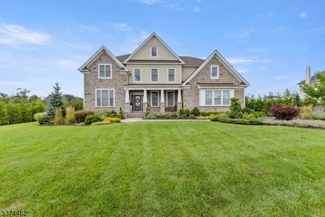 a front view of a house with a yard and potted plants