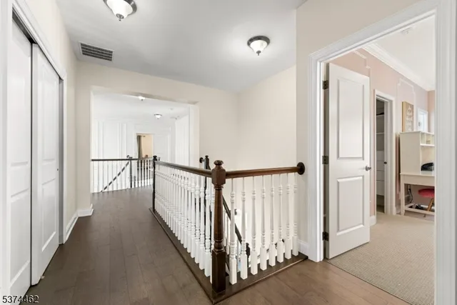a view of a hallway with a furniture and a mirror