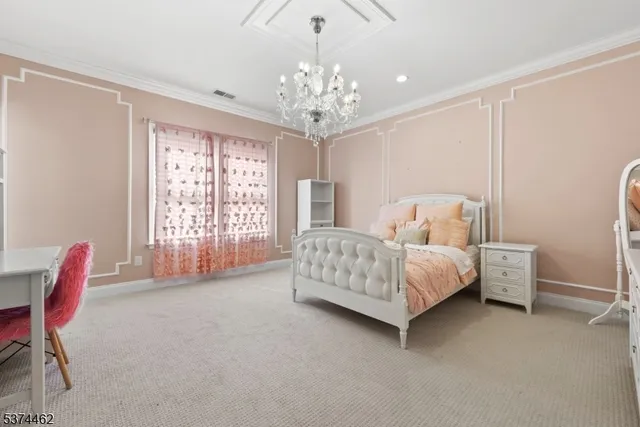 a bedroom with bed and a chandelier