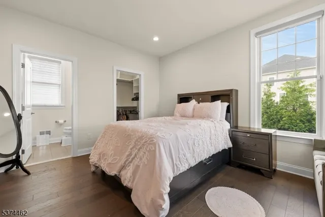 a bedroom with a bed chair and a window