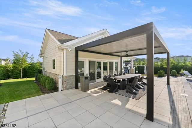 a roof deck with table and chairs potted plants and a large tree