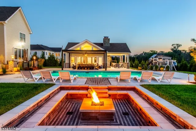a front view of house with yard swimming pool and outdoor seating