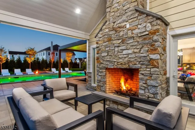 a view of a patio with couches and a fireplace
