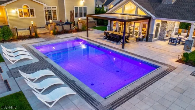 a view of a pool with sitting area