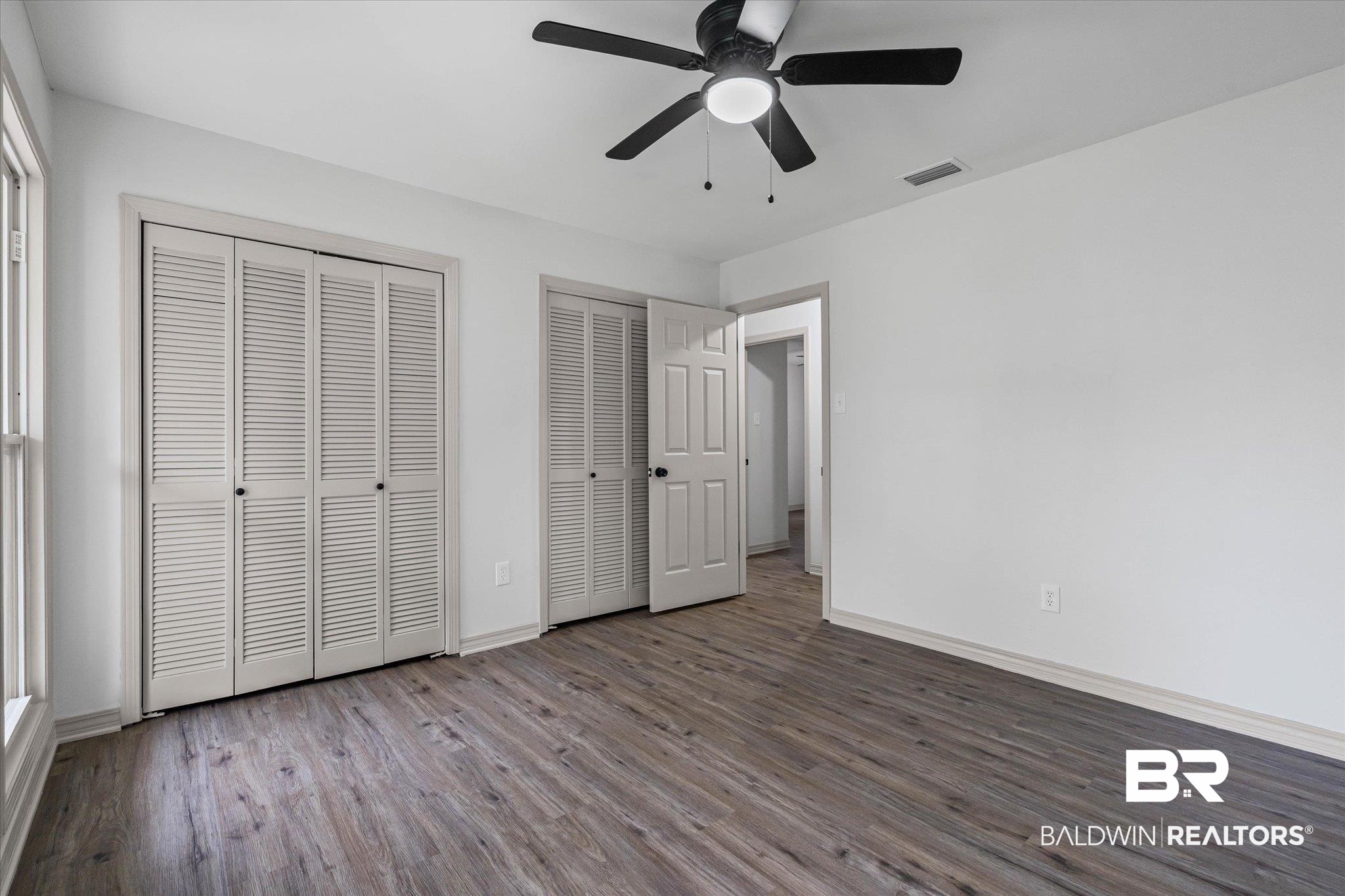 3655 Claridge Road South Mobile, AL 36608 - Photo 24 of 32 Unfurnished bedroom with wood finished floors, two closets, and a ceiling fan