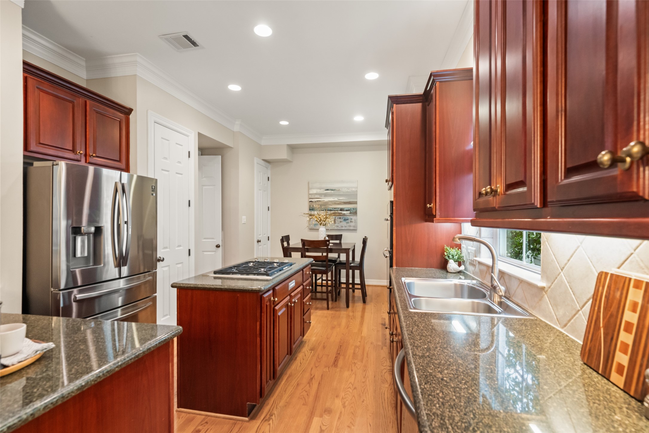 2708 Wroxton Road West University Place, TX 77005 - Photo 5 of 22 The kitchen features a cozy dine-in area and two pantries, all equipped with convenient ShelfGenie pull-out drawers for easy access and organization.