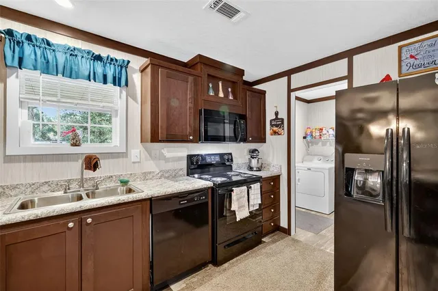 a bathroom with a granite countertop sink mirror and a bathtub