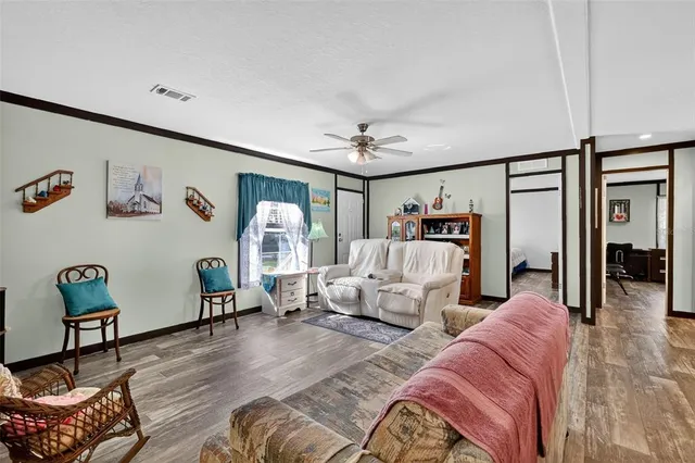 a dining room with furniture a chandelier and wooden floor
