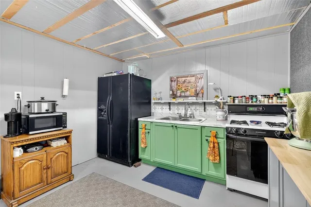 a bathroom with a sink a mirror and a painting on the wall