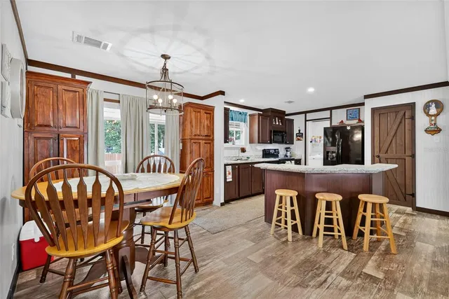a living room with furniture a flat screen tv and a table