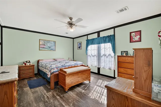 a bedroom with a large bed and a chandelier