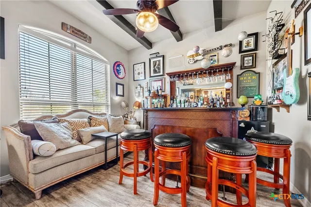 a living room with furniture a rug and a chandelier