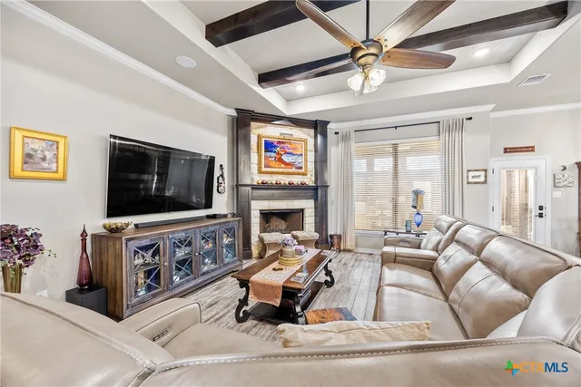 a living room with furniture a flat screen tv and a fireplace
