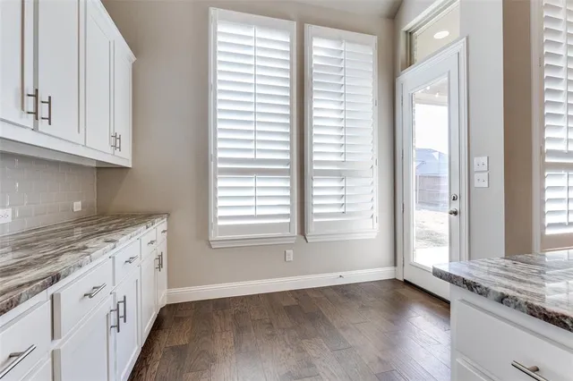 a view of a kitchen with granite countertop cabinets and a wooden floor