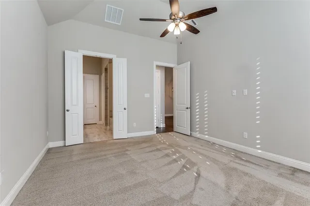 a bathroom with a granite countertop tub a sink and mirrors