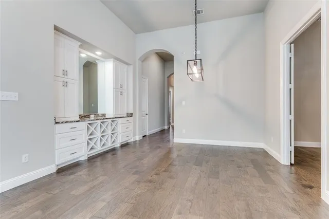 an empty room with mirror and entrance