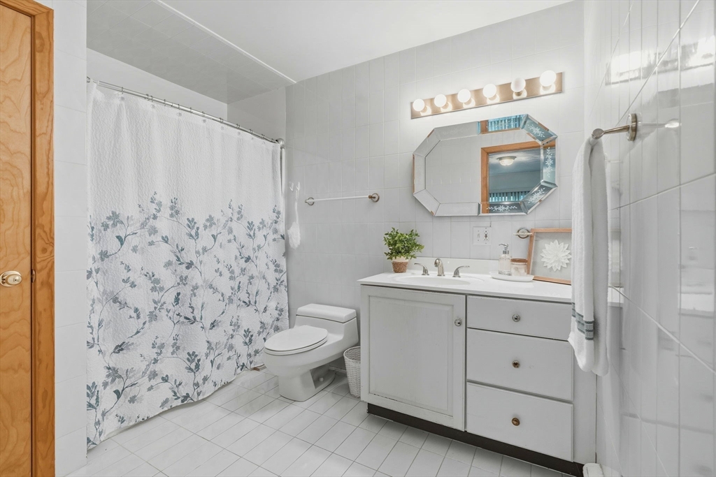 98 Lilah Lane Reading, MA 01867 - Photo 16 of 37 a bathroom with a sink toilet and shower