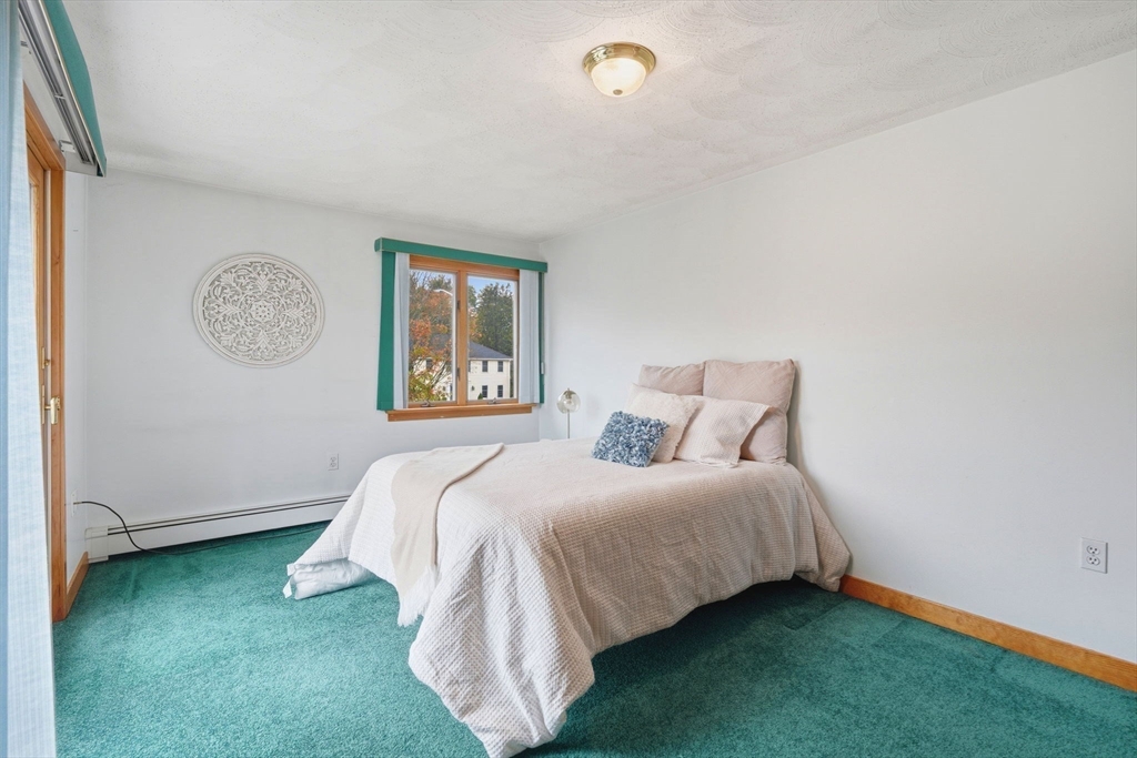 98 Lilah Lane Reading, MA 01867 - Photo 18 of 37 a bedroom with a bed and a window