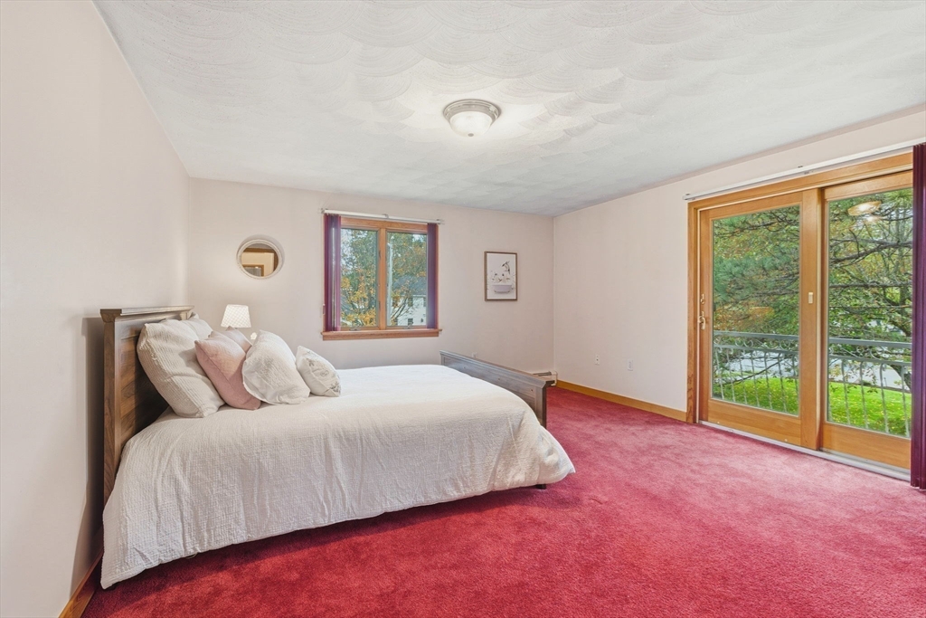 98 Lilah Lane Reading, MA 01867 - Photo 19 of 37 a large bedroom with a bed and a large window
