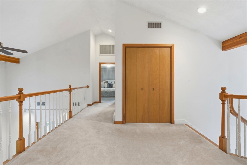 98 Lilah Lane Reading, MA 01867 - Photo 20 of 37 a view of a hallway with wooden floor