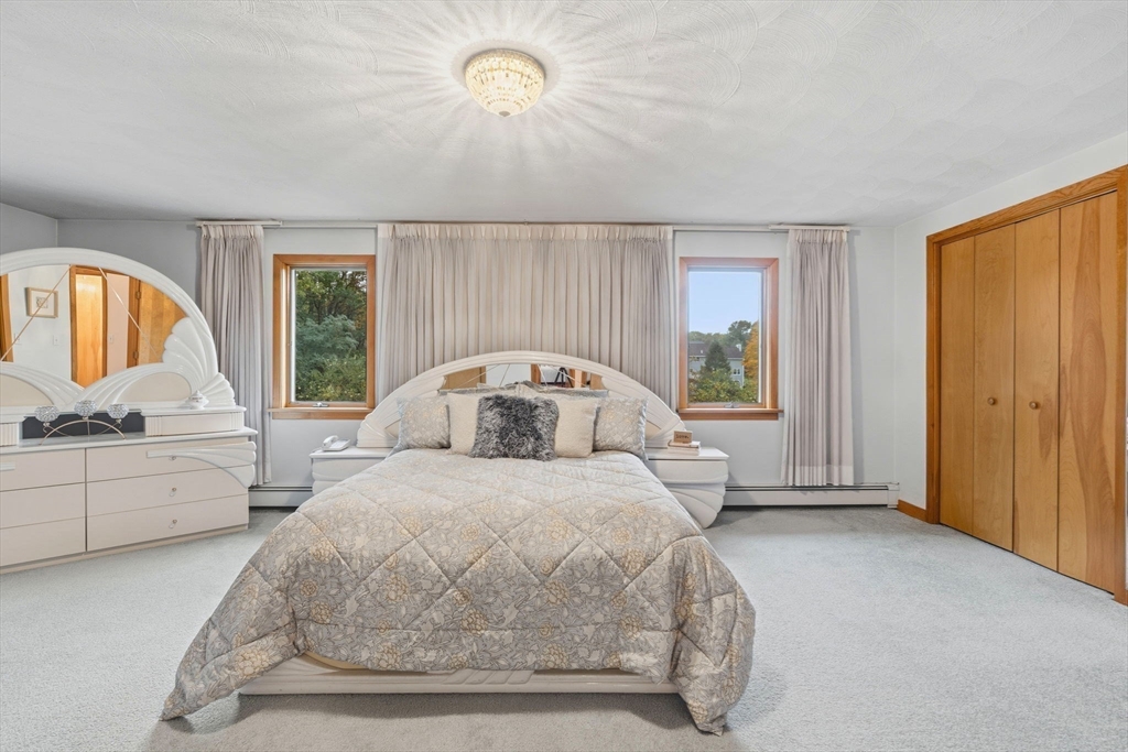 98 Lilah Lane Reading, MA 01867 - Photo 21 of 37 a bedroom with a bed and a large window