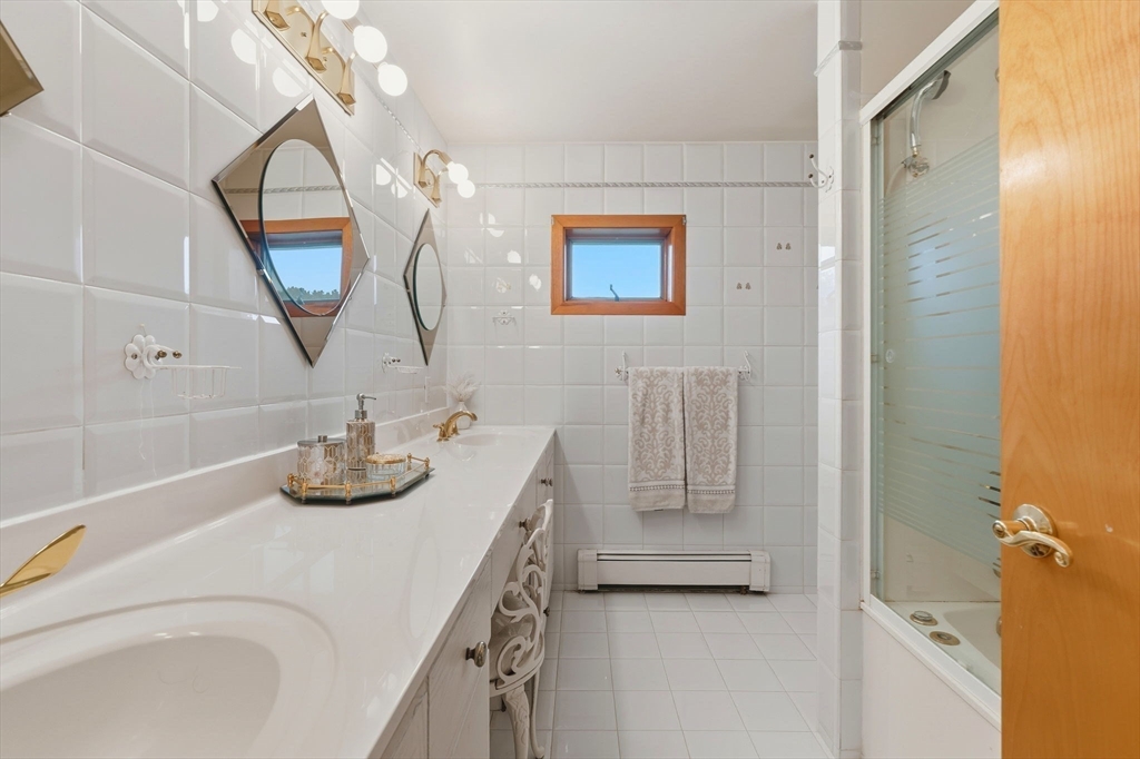 98 Lilah Lane Reading, MA 01867 - Photo 22 of 37 a bathroom with a sink and mirror