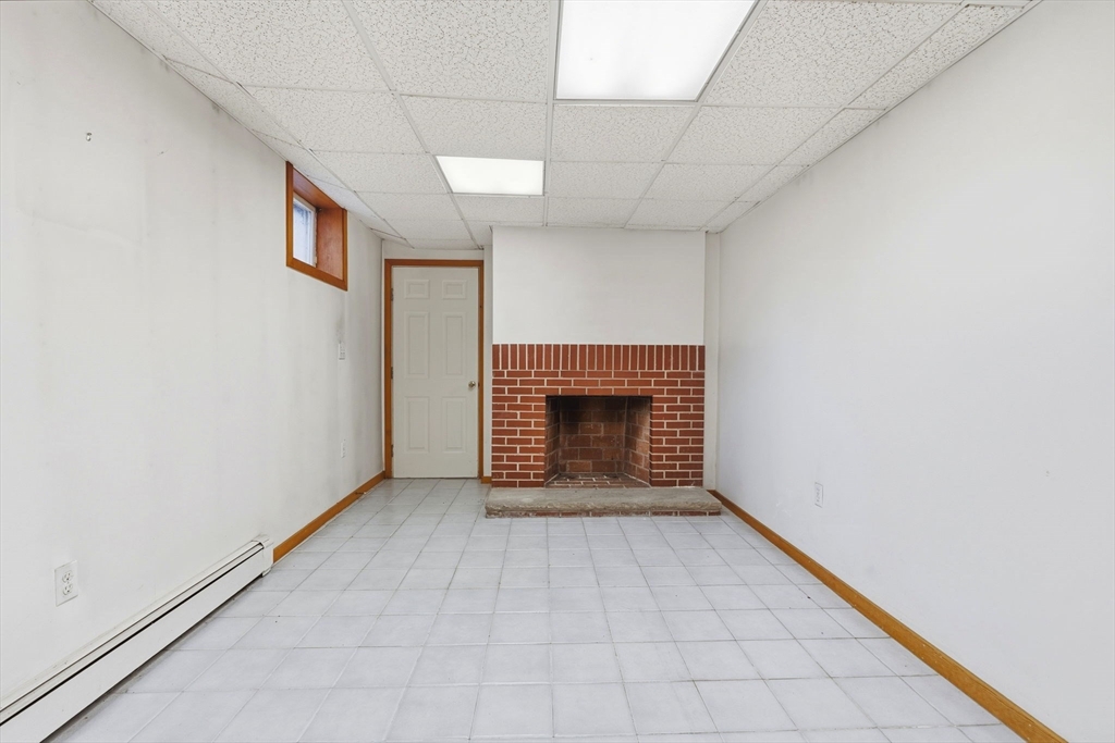 98 Lilah Lane Reading, MA 01867 - Photo 23 of 37 a view of an empty room with a fireplace
