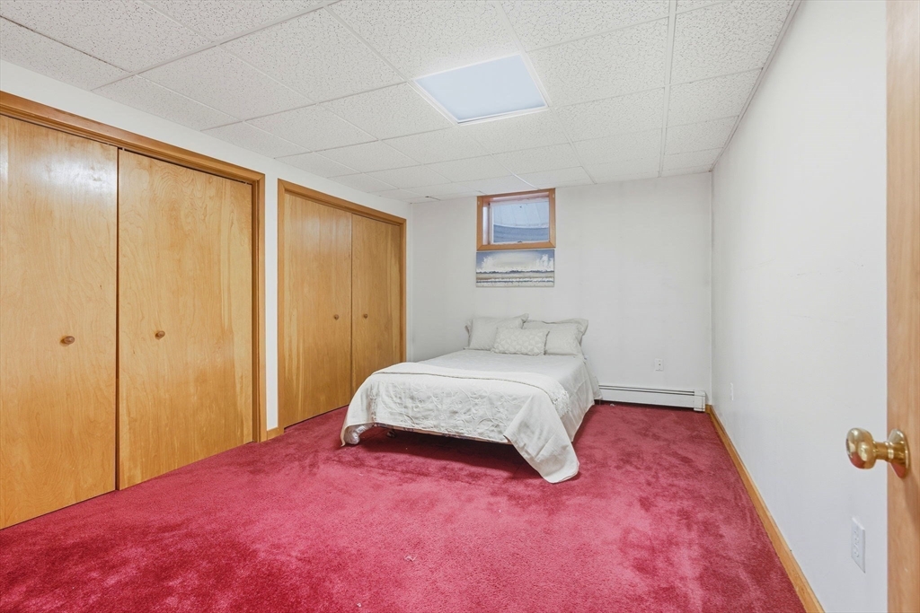 98 Lilah Lane Reading, MA 01867 - Photo 26 of 37 a bedroom with a bed and a window