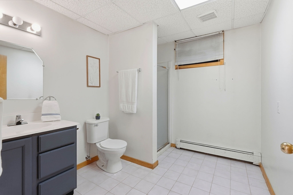 98 Lilah Lane Reading, MA 01867 - Photo 27 of 37 a bathroom with a toilet sink and a mirror