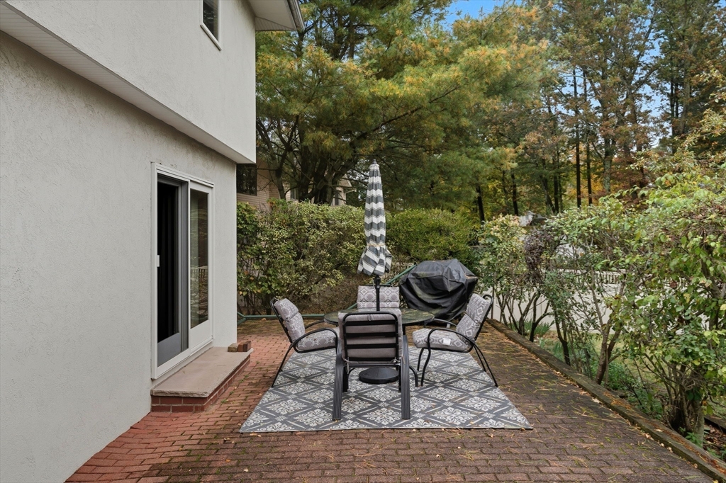 98 Lilah Lane Reading, MA 01867 - Photo 29 of 37 a backyard of a house with table and chairs