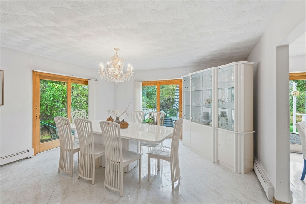 98 Lilah Lane Reading, MA 01867 - Photo 8 of 37 a view of a dining room with furniture and a chandelier
