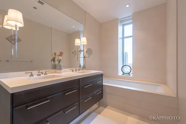 a bathroom with a sink a mirror and a bathtub