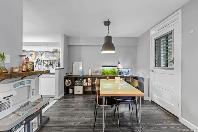 a kitchen with a table chairs stove and wooden floor