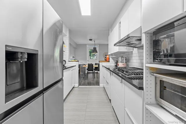 a kitchen with stainless steel appliances granite countertop a stove and a refrigerator