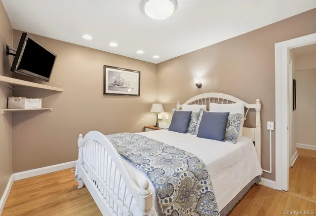 a bedroom with a large bed and a flat screen tv