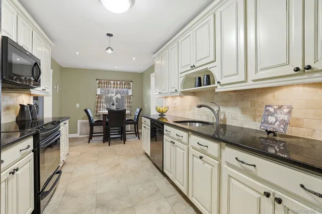 a kitchen with stainless steel appliances granite countertop a sink and cabinets