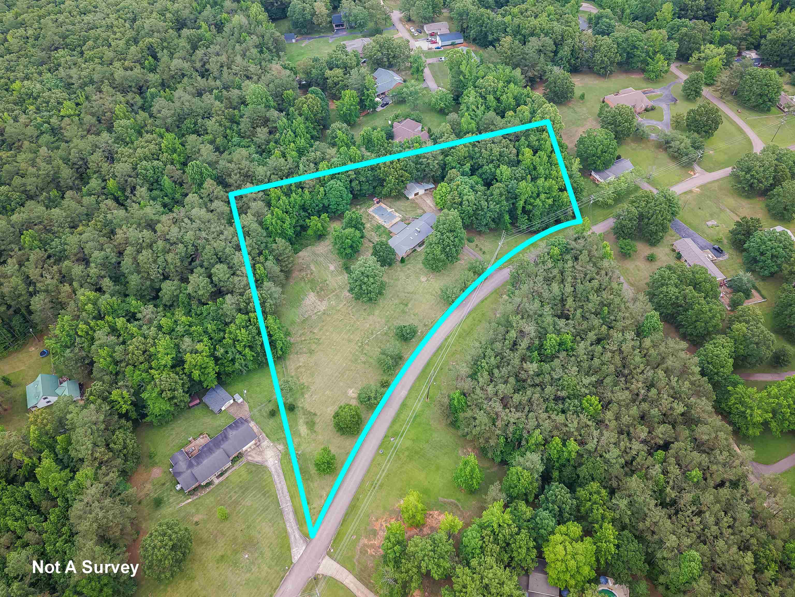 436 Skyline Road Selmer, TN 38375 - Photo 2 of 40 Expansive wooded property featuring a single-story residence, detached outbuilding, and established perimeter trees