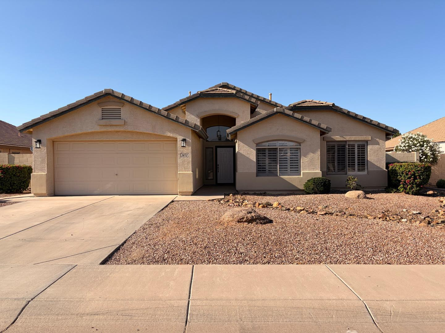 3872 East Simpson Road Gilbert, AZ 85297 - Photo 2 of 25 a front view of a house with a yard and garage