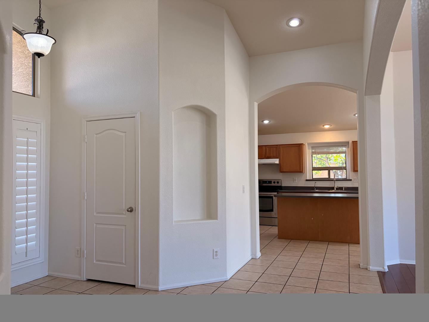3872 East Simpson Road Gilbert, AZ 85297 - Photo 5 of 25 a kitchen with stainless steel appliances kitchen island granite countertop a refrigerator and a sink