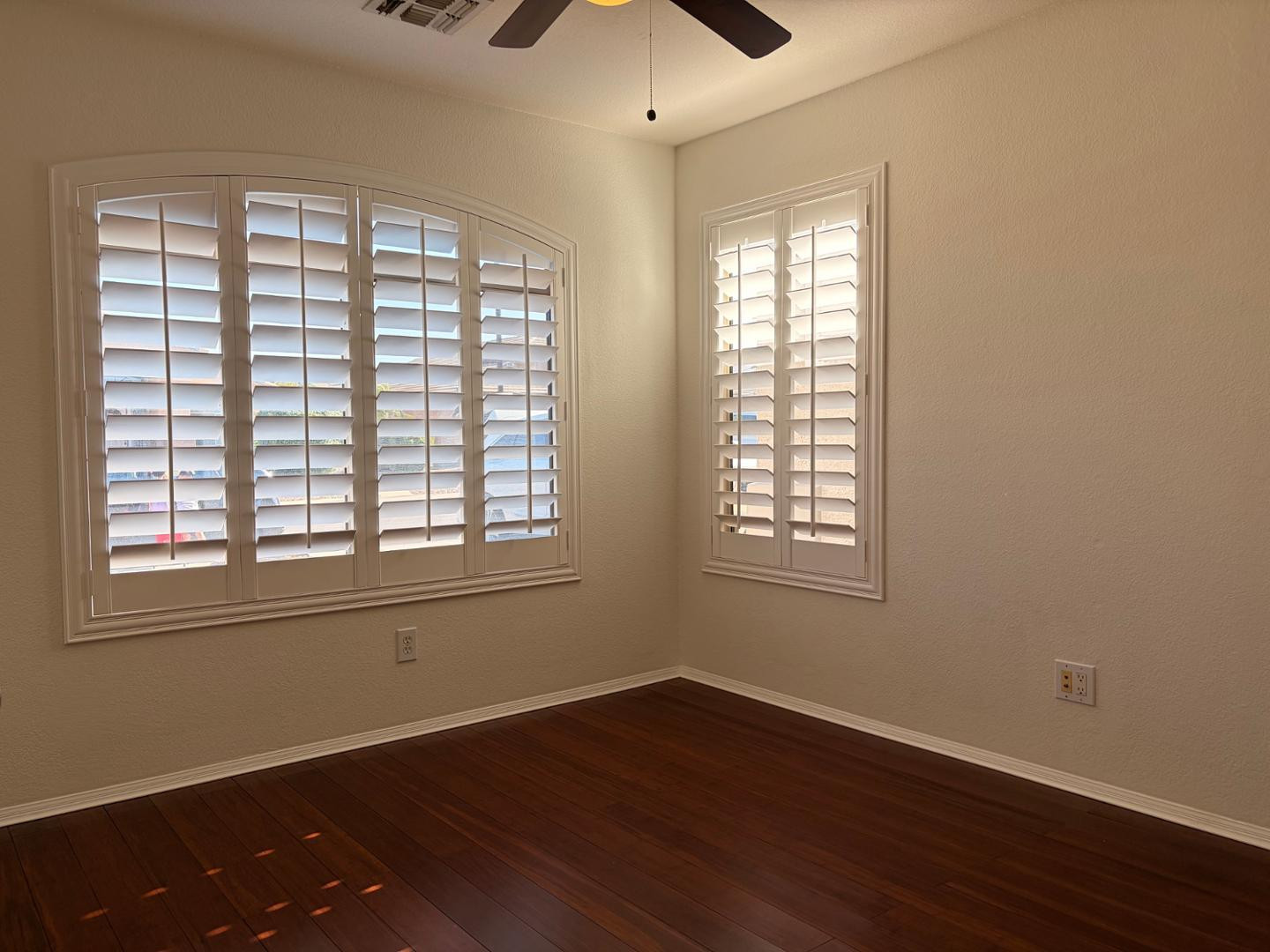 3872 East Simpson Road Gilbert, AZ 85297 - Photo 8 of 25 a view of an empty room with wooden floor and a window
